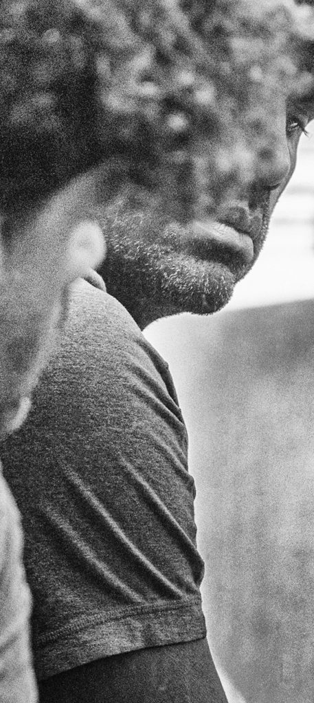 Black-and-white close crop of a bearded man in profile.