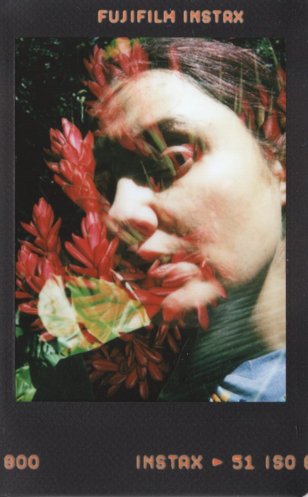 Experimental portrait of a woman layered with red flowers.