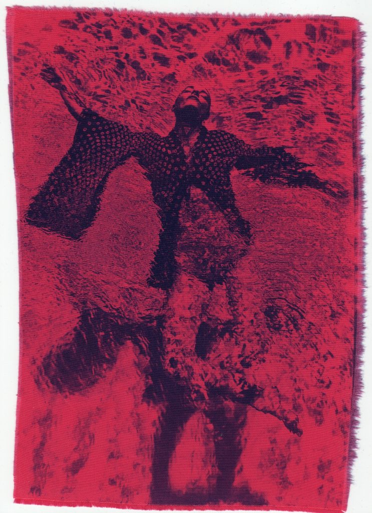Red-toned experimental print with a dark human figure.
