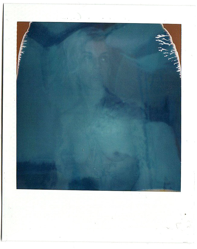Blue-green abstract instant print with soft tonal texture.