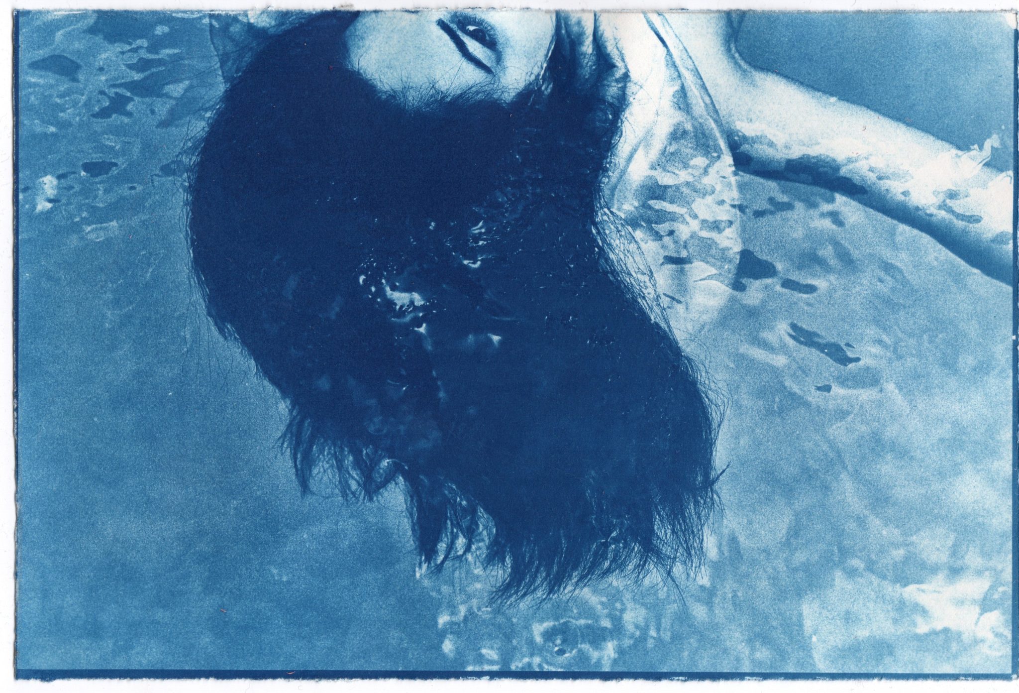 Blue-toned experimental print with an inverted human figure.