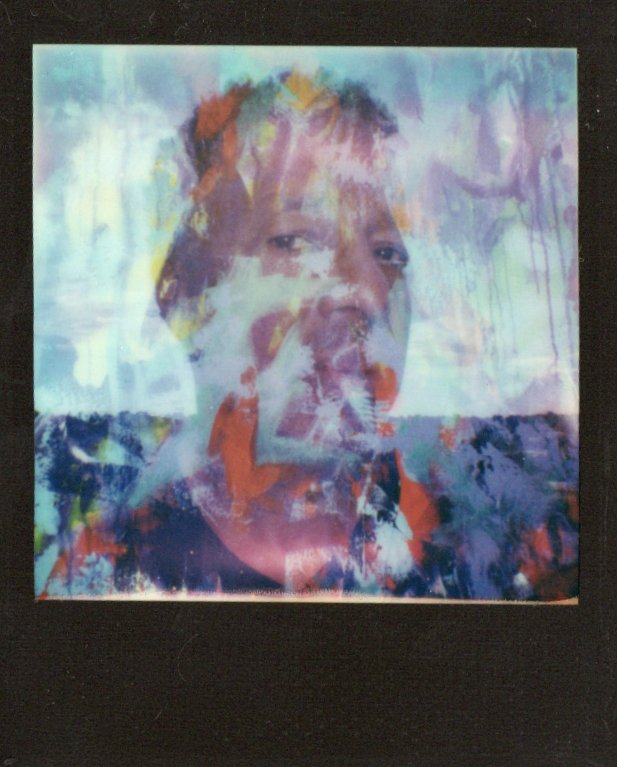 Abstract color study in blue, violet and warm tones within a dark instant frame.