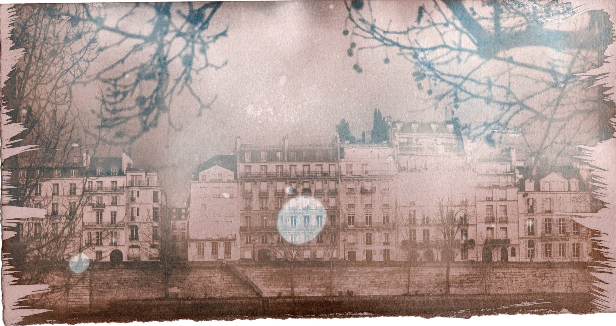 Soft pink-toned cityscape with bare branches and a pale circular reflection.